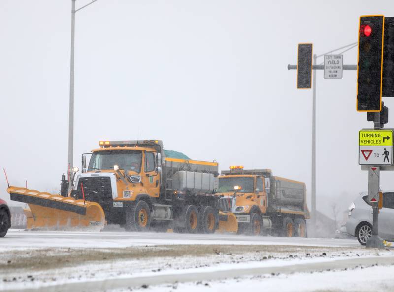 Snow plows travel on Randall Road near Batavia on Thursday, Dec. 22, 2022.