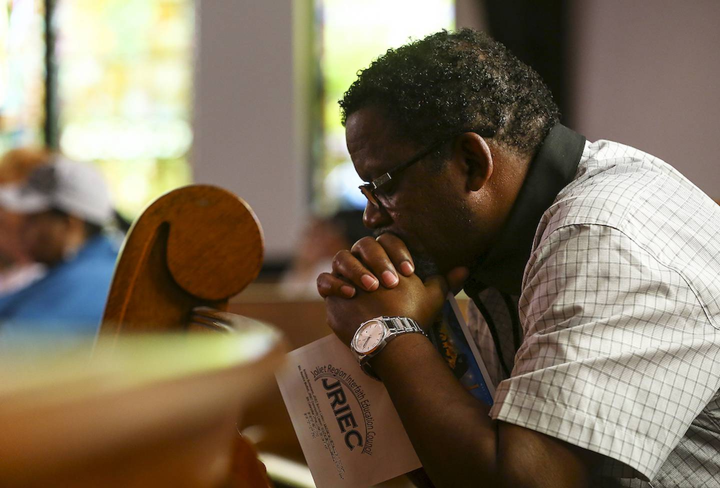 Pastor Lonnie Posley bows his head in prayer while attending Joliet's National Day of Prayer celebration held Thursday at old Central Church in Joliet.