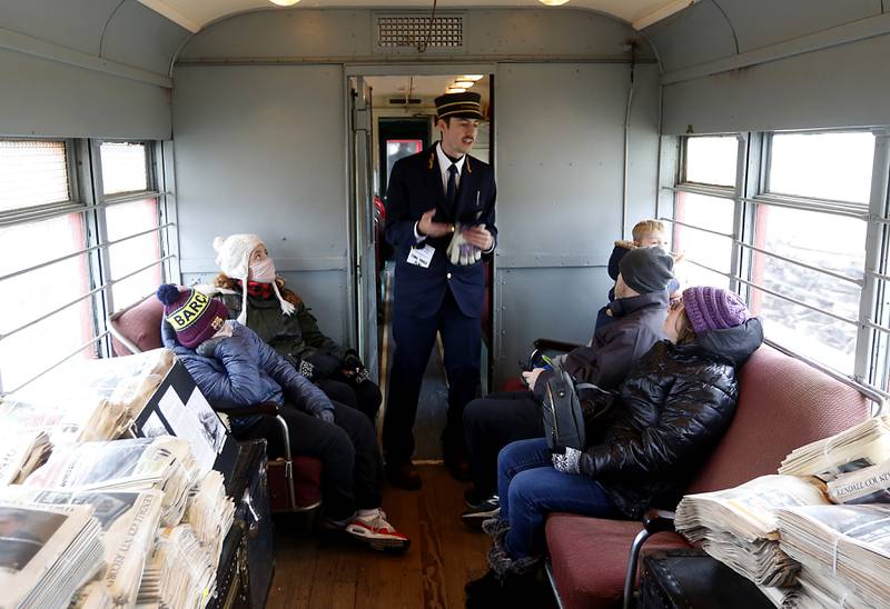 Conductor Ryan Daleen talks with riders on a North Shore train Saturday, Jan. 21, 2023, as the Illinois Railway Museum celebrates its 70 anniversary with the first of many celebrations by commemorating the 60 years since the abandonment of the Chicago North Shore and Milwaukee Railroad.