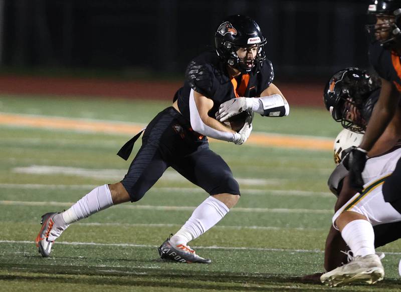 DeKalb's Talen Tate tries to get through the Waubonsie Valley line during their game Friday, Sept. 29, 2023, at DeKalb High School.