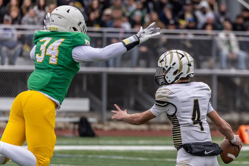 Providence's Jaxon Hutton leaps before sacking Oak Forest's Daniel Chopp during a 5A varsity football semifinal game at Providence Catholic High School on Nov. 22, 2025.
