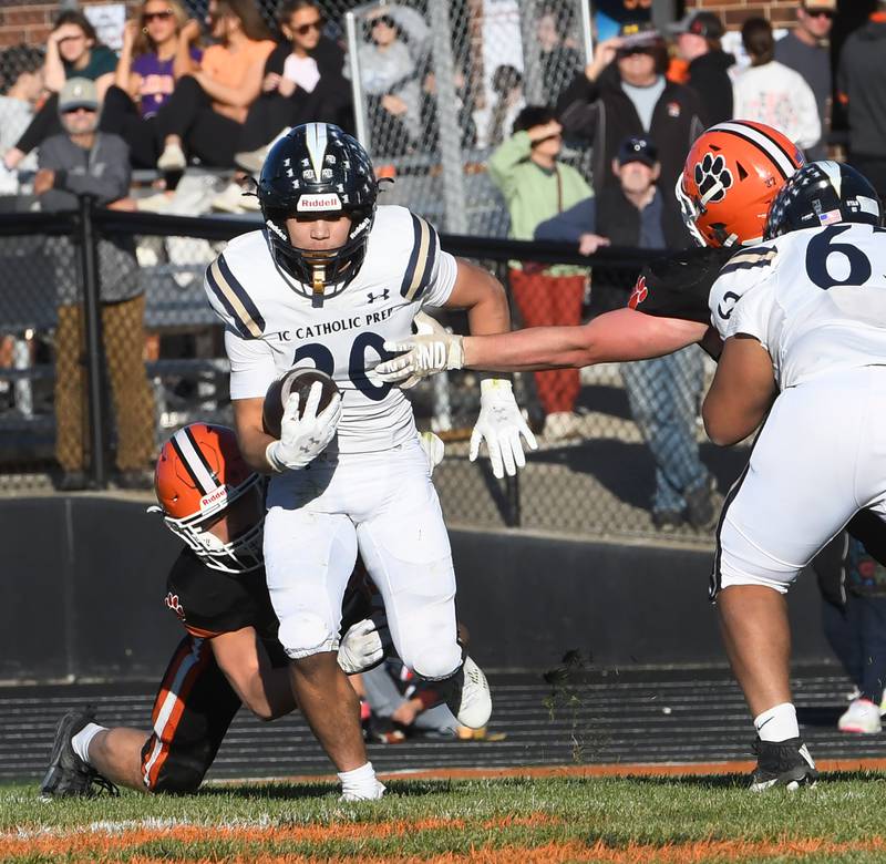 Elmhurst IC Catholic's KC Kekstadt (20) avoids Byron defenders during 3A quarterfinals at Byron High School on Saturday, Nov. 15, 2025.