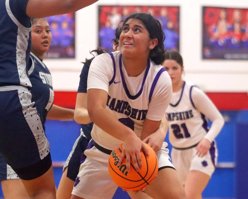 Hampshire’s Jiselle Lopez works under the hoop against South Elgin in varsity girls basketball Komaromy Classic tournament  action on Monday, Dec. 29, 2025, at Dundee-Crown High School in Carpentersville.