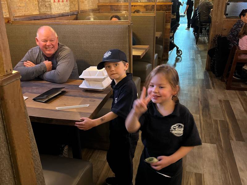 Brandon and Aria Coli, 6 and 5, walk around to tables, talking to customers and asking them if they enjoyed dinner, during Georgio's Pizza's 20th anniversary celebration on Nov. 7, 2022. Brandon Coli is the son of owner Brian Coli, and Aria is the daughter of Brian Coli's brother, James Coli, who is the operations manager for the two locations in Crystal Lake and South Barrington.