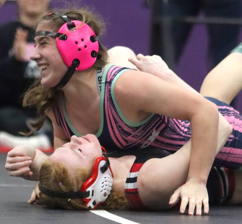 Woodstock’s Hannah Olsen grins after pinning Maine South’s Alyssa Gianola at 125 pounds in IHSA Regional wrestling semifinal action on Saturday, Feb. 1, 2025, at  Hampshire High School  in Hampshire.