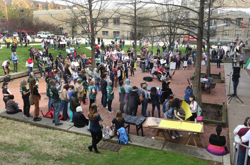 Dozens of people listen to speakers Wednesday, April 23, 2025, during a rally to support Northern Illinois University’s international students, faculty and staff, in front of Founders Memorial Library at NIU in DeKalb.