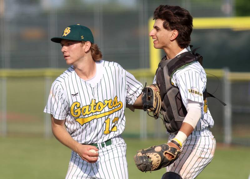 Crystal Lake South’s Mark Pachla, left, celebrates with catcher Tony Amici after a 4-1 Gator win over Lake Forest in Class 3A baseball regional action at Crystal Lake Thursday.