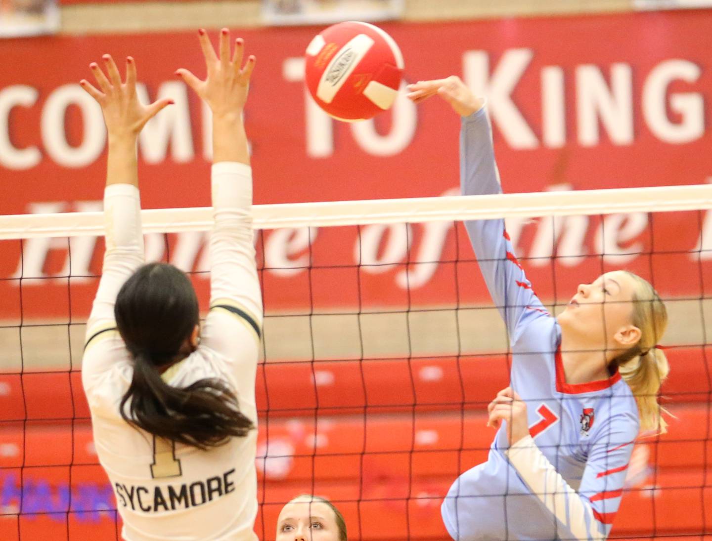 Ottawa's Ryleigh Stevenson spikes the ball past Sycamore's Grace Lichtart on Thursday, Oct. 12, 2023 at Kingman Gym.