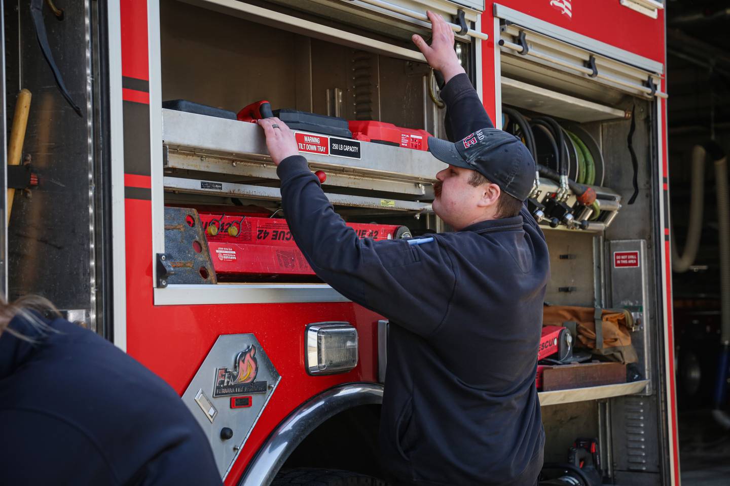 Harvard Fire Protection District firefighters check supplies and gear on Tuesday, March 11, 2025.