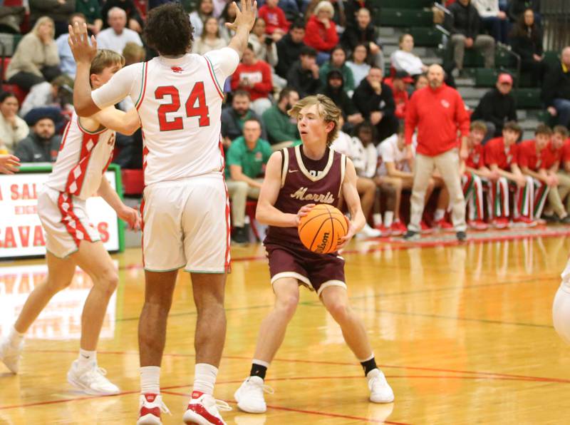 Morris's Landon Norris gets stuck in the lane as L-P defenders Braylin Bond and Marion Persich defend on Friday, Dec. 6, 2024 in Sellett Gymnasium at L-P High School.