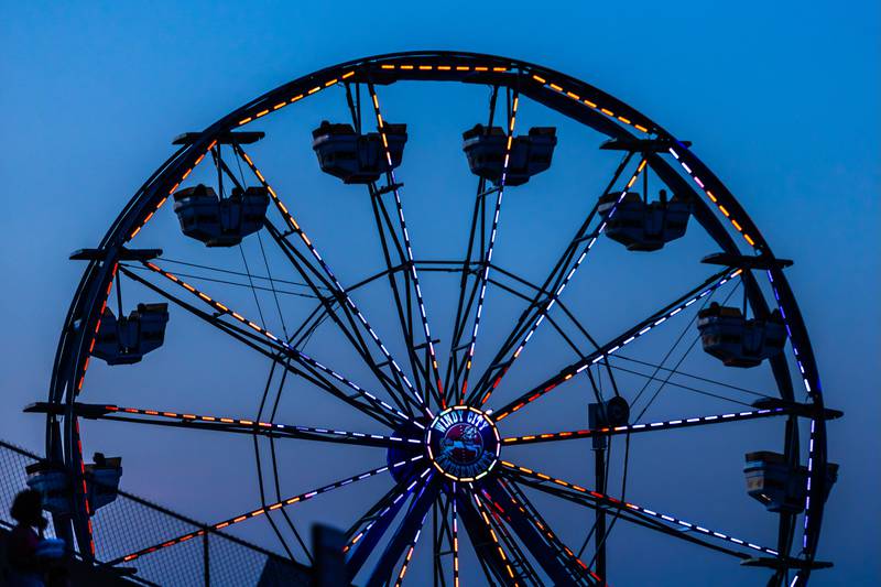 The Ferris wheel lights up the sky above Busey Bank Field at Joliet Memorial Stadium during Taste of Joliet on June 21, 2025.
