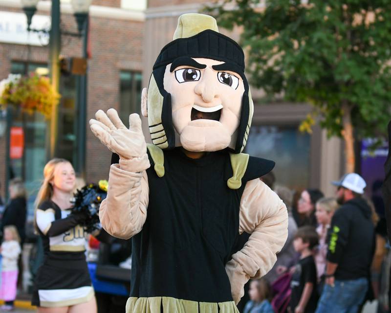 Sycamore High School's Spartan mascot waves to the crowd as he walks in the Homecoming parade on Wednesday, Oct. 8, 2025, in downtown Sycamore.