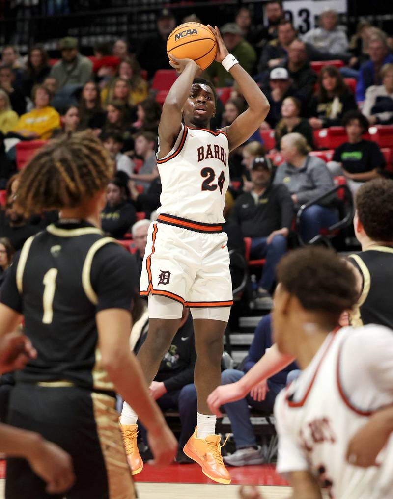 DeKalb's Myles Newman shoots over the Sycamore defense Friday, Jan. 30, 2026, during the FNBO Challenge at the Convocation Center at Northern Illinois University in DeKalb.