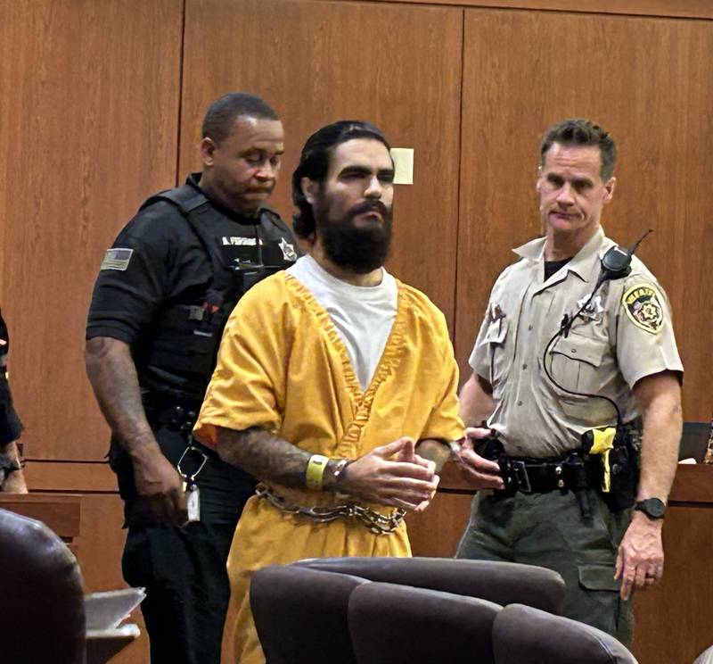 Jonathon Gounaris is escorted into an Ogle County courtroom on Monday, July 22, 2024. He is charged with the attempted murder of three police officers following a standoff at his home near Dixon.