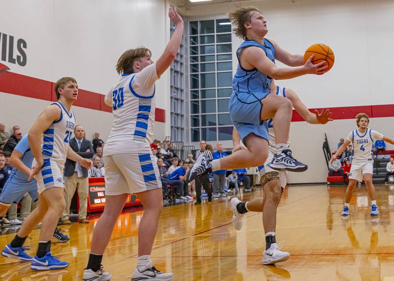 Elijah Endress of Bureau Valley leaps past defenders on a drive to the hoop during the Colmone Classic on December 7, 2024 at Hall High School.