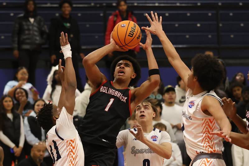 Bolingbrook's Brady Pettigrew takes the contested shot against Romeoville on Tuesday, Dec. 2, 2025 in Romeoville.