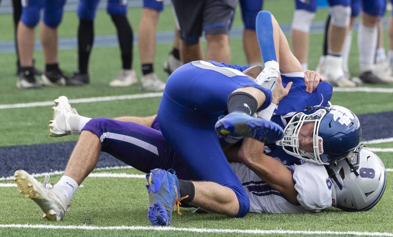 Newman’s John Rowzee holds on to a catch after being brought down by Ridgeview-Lexington’s Eric Payne Saturday, Nov. 1, 2025, in round one of the Class 2A football playoffs.