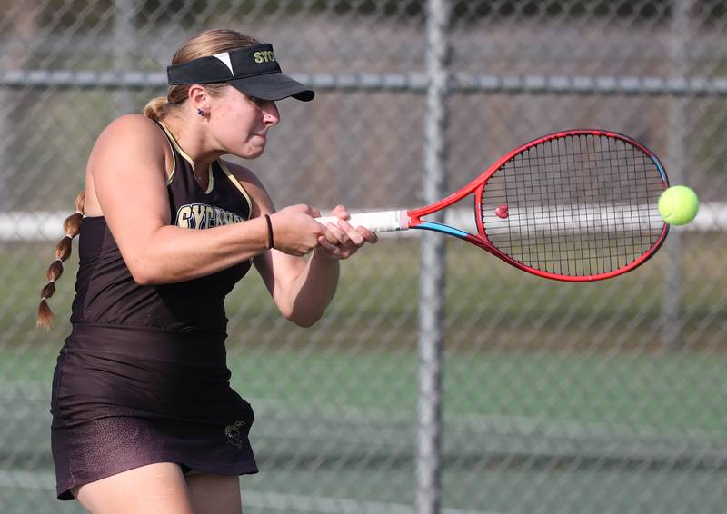 Sycamore’s Maggie Klein hits a backhand during her doubles match against DeKalb Wednesday, Sept. 18, 2024, at Sycamore High School.