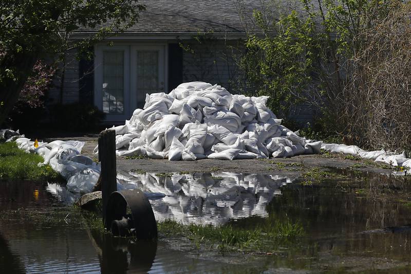 Sandbags protect a home in Holiday Hills  as flooding continues on the Fox River on Wednesday, April 22, 2026.