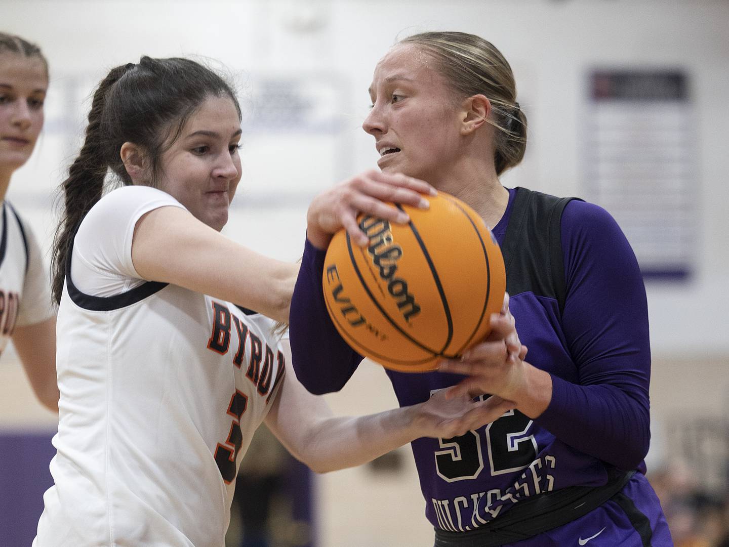 Dixon's Makenzie Toms and Byron’s Layni Marchini grasp at a ball Friday, Dec. 27, 2024, during the Dixon Girls KSB Holiday Basketball Classic.