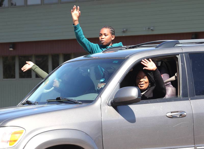 Supporters wave at protesters from a passing car on Sycamore Road in DeKalb Saturday, March 28, 2026, during a No Kings march and rally against the federal actions of President Donald Trump and his administration.