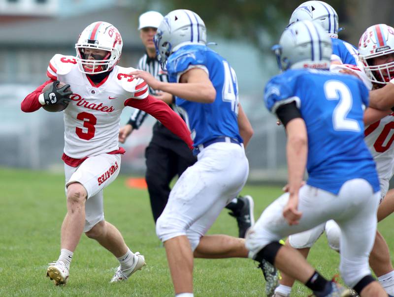 Ottawa’s Hayden Swett runs the ball in varsity football at Larry Dale Field on the campus of Woodstock High School Saturday.