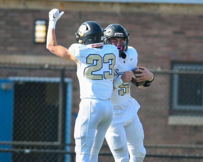 Sycamore's Kyle Prebil (5) celebrates with teammate Sycamore Dylan Hodges (23) after scoring a touchdown in the first quarter of the game on Saturday Nov. 4, 2023, while taking on Morgan Park at Gately Stadium in Chicago.