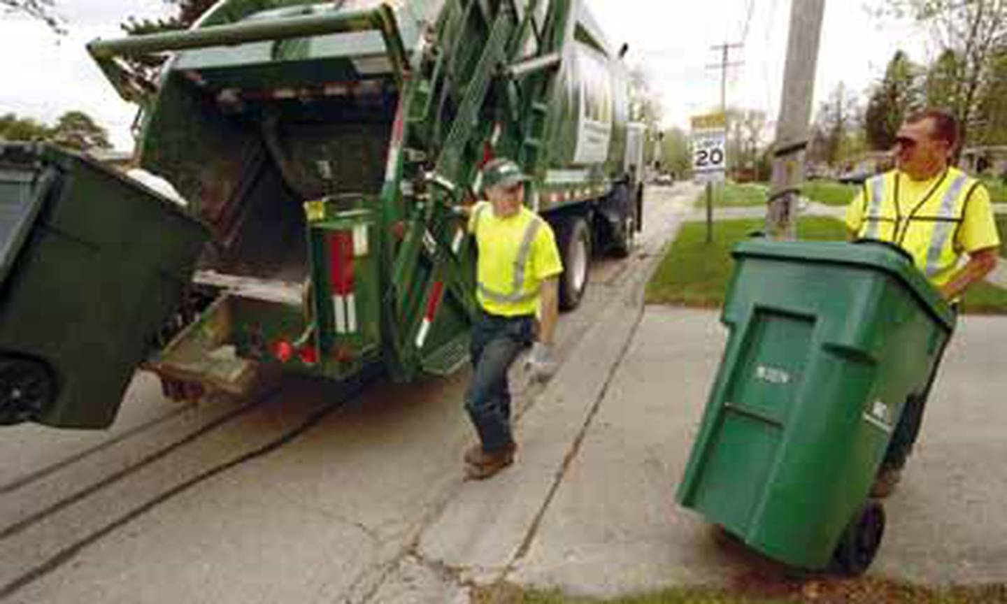 A worker collects garbage in this file photo. Trash collection is the fifth most dangerous job according to the Labor Department.