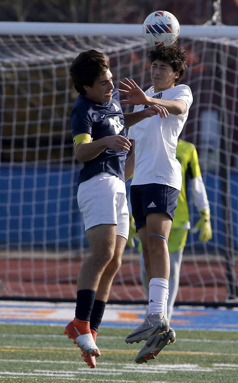Lemont's Vincenzo Mancini heads the ball away from Belleville Althoff Catholic's Bo Gomric during an IHSA Class 3A state semifinal soccer match on Friday, Nov. 8, 2024, at Hoffman Estates High School.
