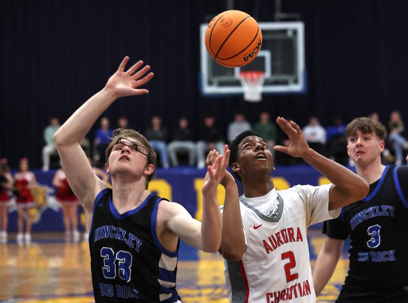 Hinckley-Big Rock’s Marshall Ledbetter (left) and Aurora Christian's James Baker go after a rebound during their sectional final game Friday, March 7, 2025, at Somonauk High School.