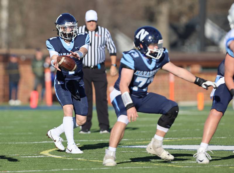 Nazareth's Logan Malachuk (1) takes a snap against St. Francis' during the boys varsity IHSA 5A semifinal between Nazareth Academy and St. Francis high school in La Grange Park, IL on Saturday, Nov. 18, 2023.