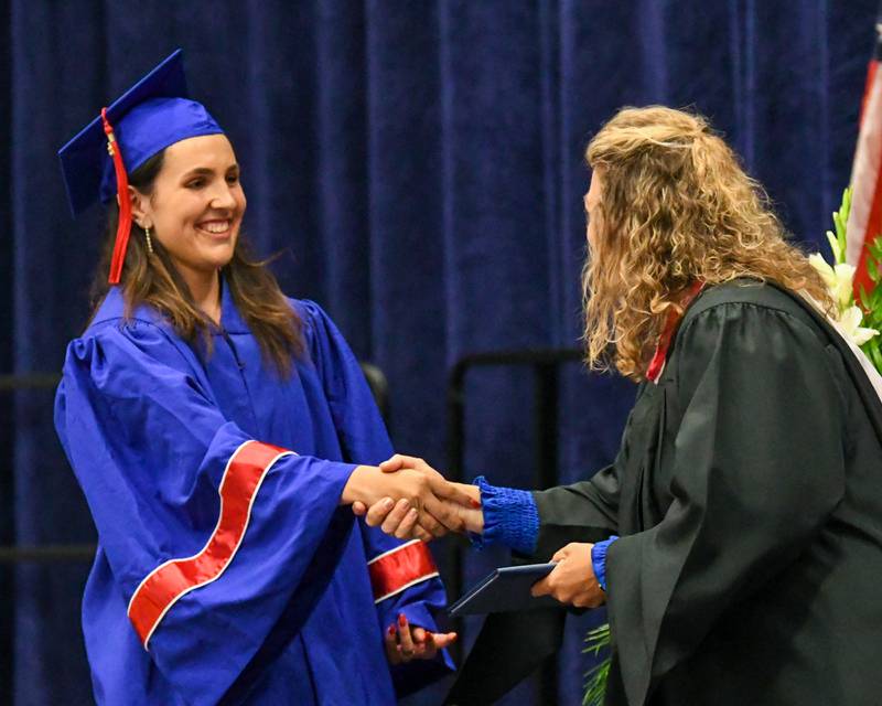 Glenbard South graduate Amanda Harris receives her diploma during graduation on Thursday May 23, 2024, held at Glenbard South High School.