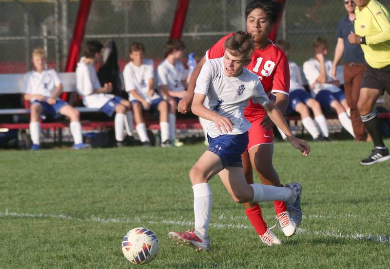 Princeton's Parker Nink kicks the ball ahead of Ottawa's Joan Gutierrez on Tuesday, Oct. 3, 2023 at Ottawa High School.