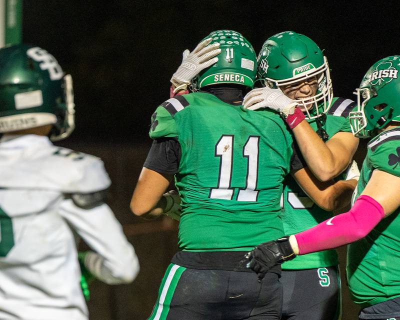 Zebadiah Maxwell (11) of Seneca and teammate Brady Sheedy (23) embrace one another in celebration of touchdown on Friday, Oct. 10, 2025 at Seneca High School in Seneca.