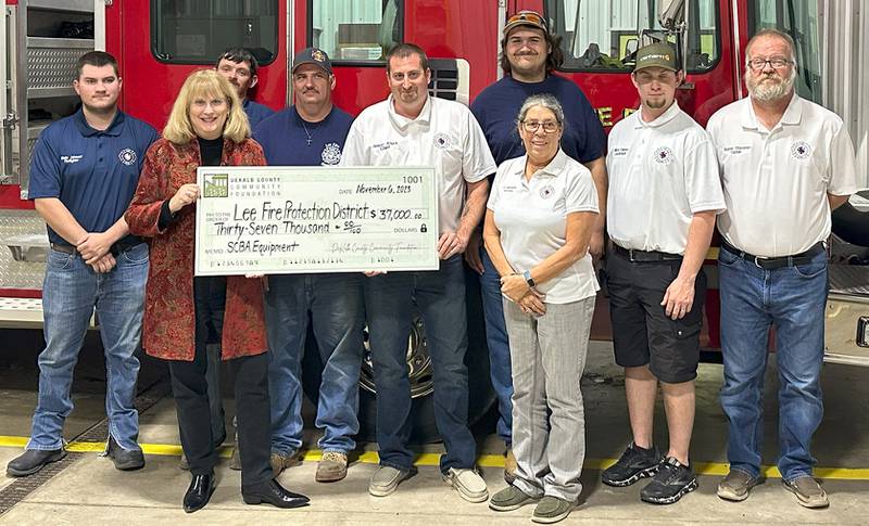 (From left) DeKalb County Community Foundation board president Christine Johnson, Lee Fire Protection District Chief Jason Aters, and Lee Fire Protection District members