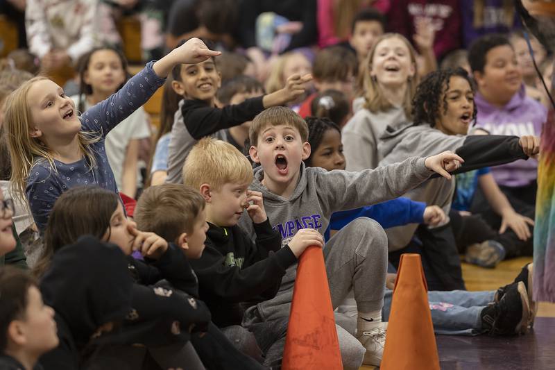 Madison School students react to an experiment by Steve Belliveau Friday, March 7, 2025, during a presentation on science.