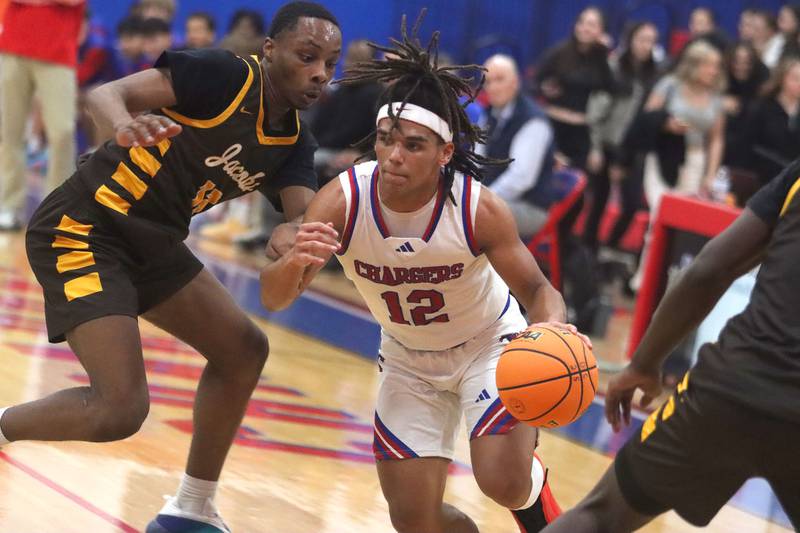 Jacobs’ Elijah Bell, left, catches up to Dundee-Crown’s Anthony Spain in varsity boys basketball on Friday, Dec. 12, 2025, at Dundee-Crown High School in Carpentersville.