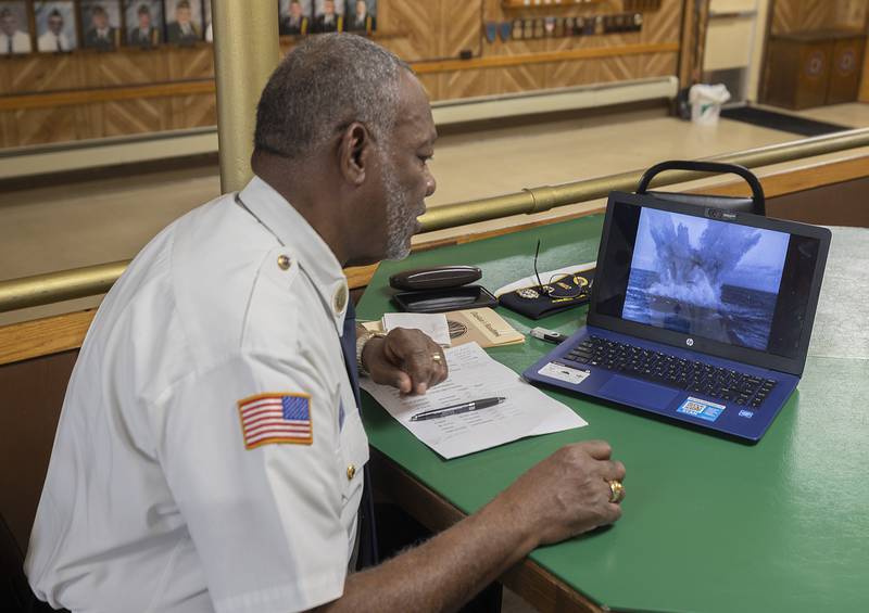 Military chaplain Gordon Harris reviews the movie he will show during the Feb. 2 presentation at the Sterling American Legion.