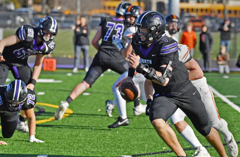 Downers Grove North quarterback Owen Lansu scrambles to the end zone with the Trojans’ first touchdown of the game during a Class 7A quarterfinal agains Lincoln-Way West on November 15, 2025 at Downers Grove North High School in Downers Grove .