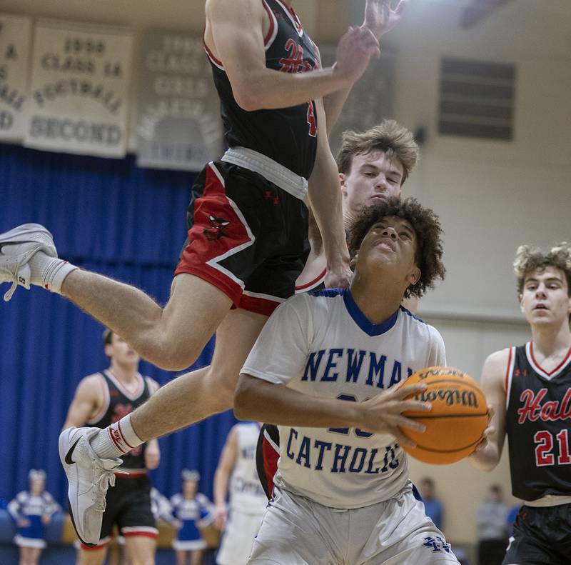 Newman’s Tyson Williams is fouled by Hall’s Luke Bryant below the basket Friday, Jan. 17, 2025 at Newman High School.