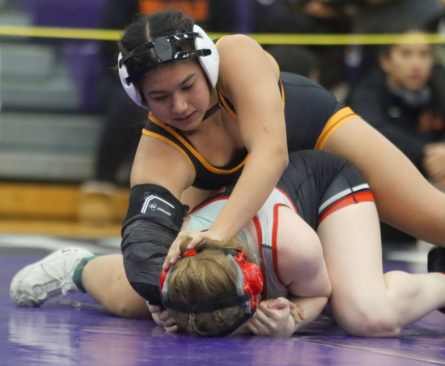 McHenry’s Natalie Corona, top, battles Mundelein’s Khloe Heerdegen at 145 pounds in Whip-Pur Women’s Classic varsity girls wrestling on Saturday, Dec. 20, 2025, at Hampshire High School in Hampshire.
