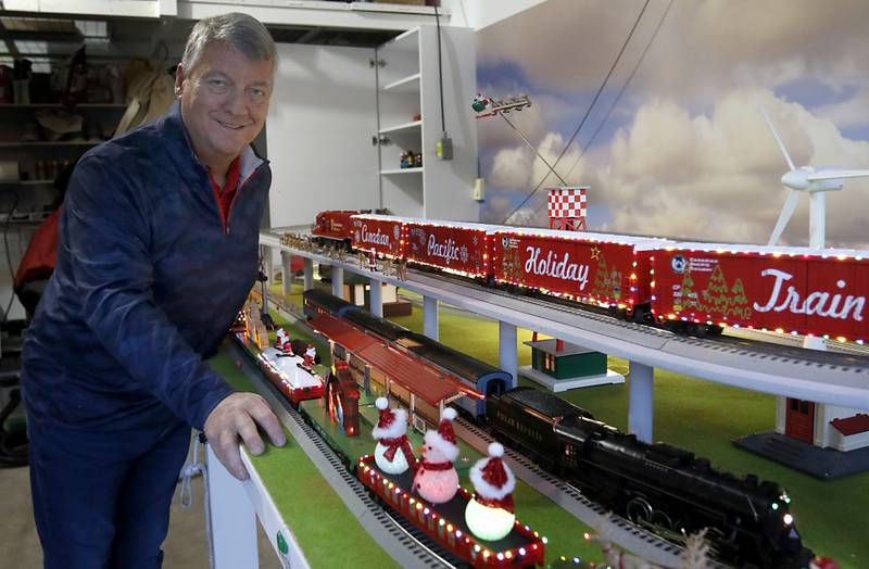 John Smith, president of the McHenry Riverwalk Foundation, with his holiday-themed trains on Thursday, Dec. 19, 2024, at his home in McHenry. He has been opening up his garage along the riverwalk during the weekends for people to see the trains.