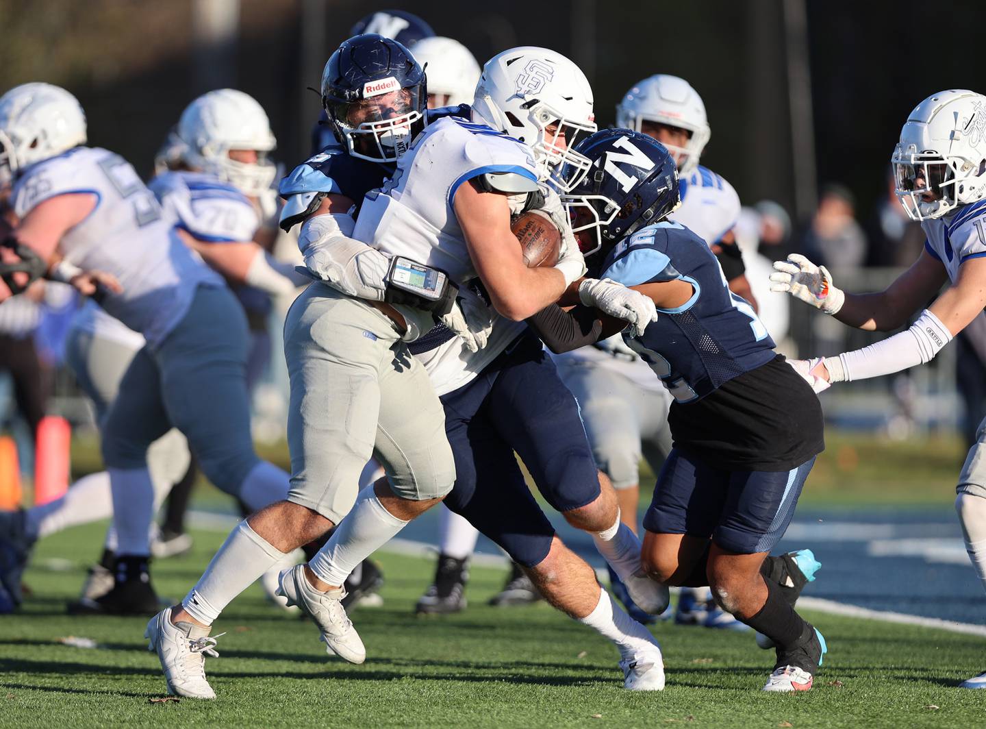 Nazareth's Gabe Kaminski (5) wraps up St. Francis' Domenic Beres (5) during the boys varsity IHSA 5A semifinal between Nazareth Academy and St. Francis high school in La Grange Park, IL on Saturday, Nov. 18, 2023.