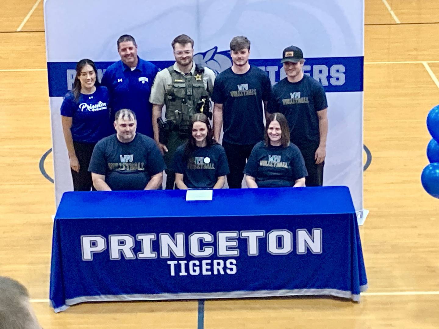 Princeton senior Keighley Davis (front, center) was accompanied for her college signing Tuesday evening by her parents, Spencer and Annette; and (back row) PHS coaches Gina and Andy Puck and her brothers Wyatt, Teegan and Drake.