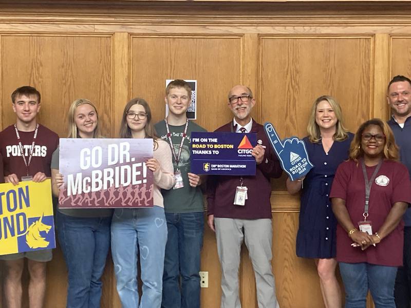 Robert McBride stands with students, staff, and CITGO Public Relations Manager Jen Hannon at his Boston Marathon surprise send off Friday, April 17, 2026.