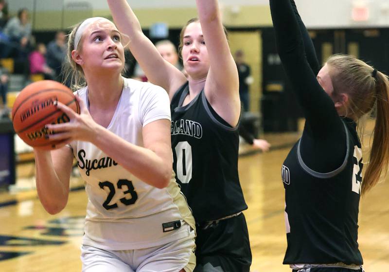 Sycamore's Evyn Carrier looks to score over two Kaneland defenders during the Class 3A regional final game Friday, Feb. 17, 2023, at Sycamore High School.