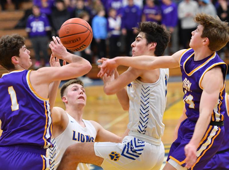 Downers Grove North's Jake Riemer (1) and Maxwell Haack (right) battle Lyons Township's Graham Smith and Matthew DeSimone (second from right) for a loose ball during a game on Jan. 6, 2023 at Lyons Township High School in LaGrange.