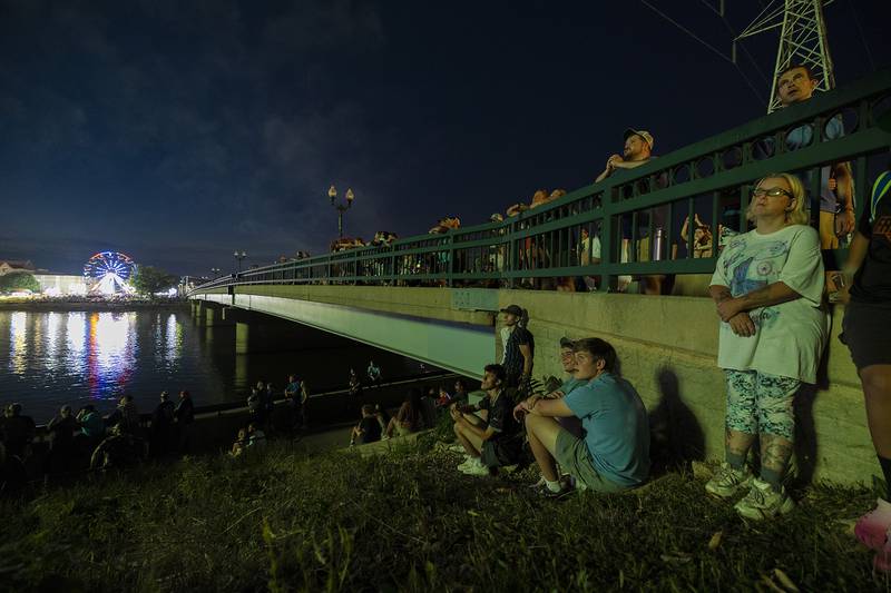 Spectators watch as fireworks illuminate the sky Monday, July 3, 2023 in Dixon.