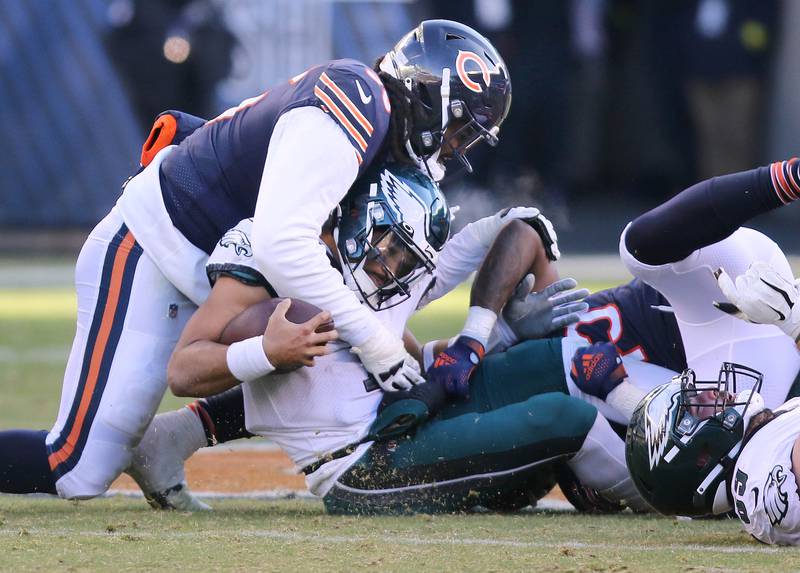 Chicago Bears defensive tackle Armon Watts and Chicago Bears linebacker Joe Thomas sack Philadelphia Eagles quarterback Jalen Hurts during their game Sunday, Dec. 18, 2022, at Soldier Field in Chicago.