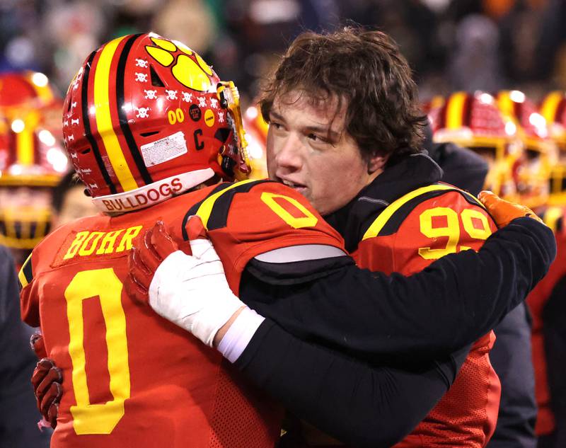 Batavia players embrace after their Class 8A state championship loss to Mt. Carmel Saturday, Nov. 30, 2024, in Hancock Stadium at Illinois State University in Normal.
